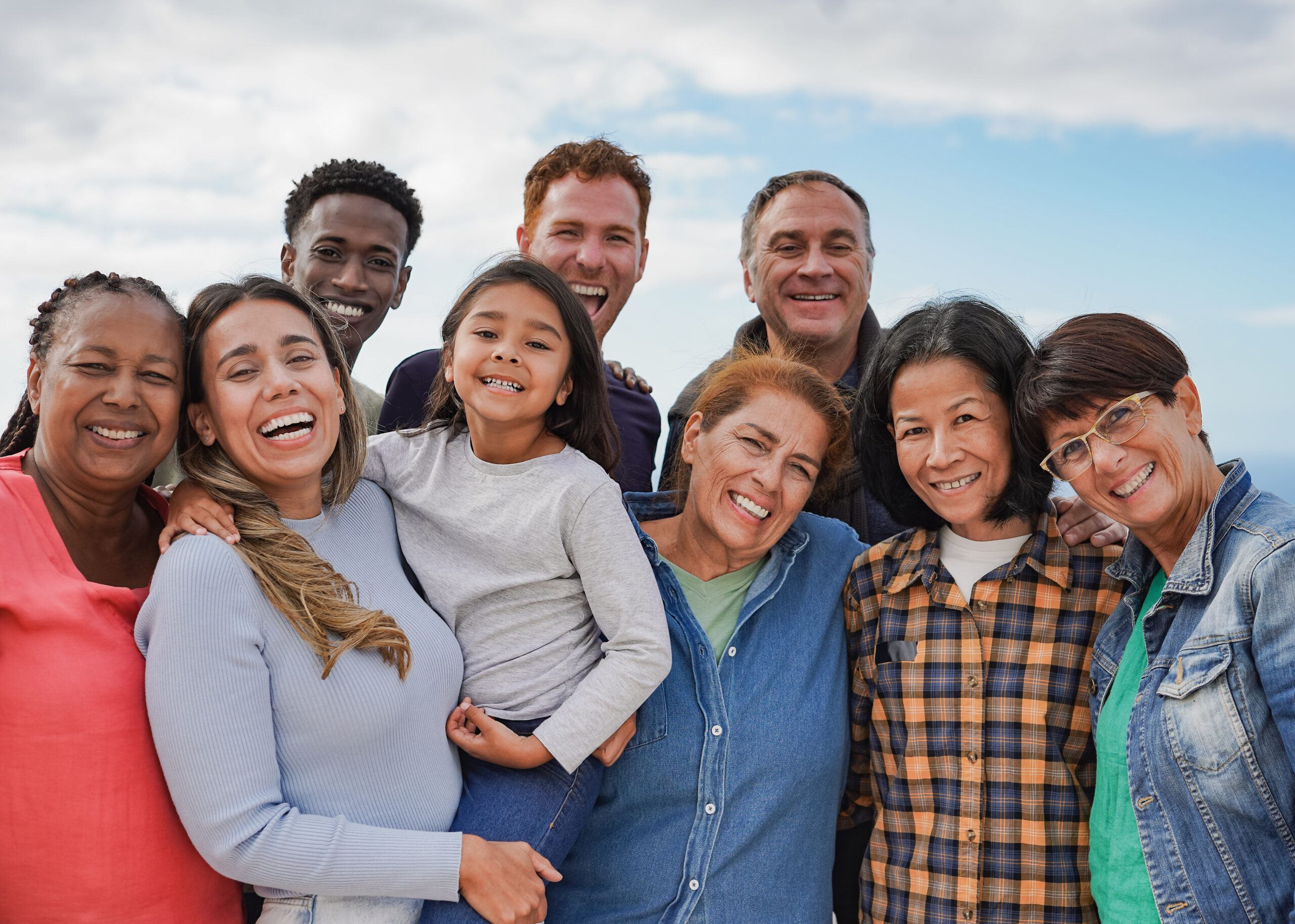 Multi generational friends smiling on camera outdoor